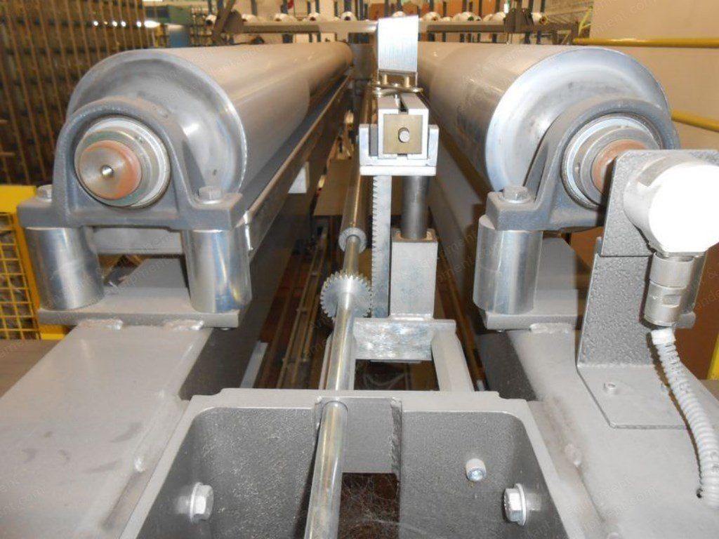 Close-up of the beam rollers and drive on a re-beaming machine.