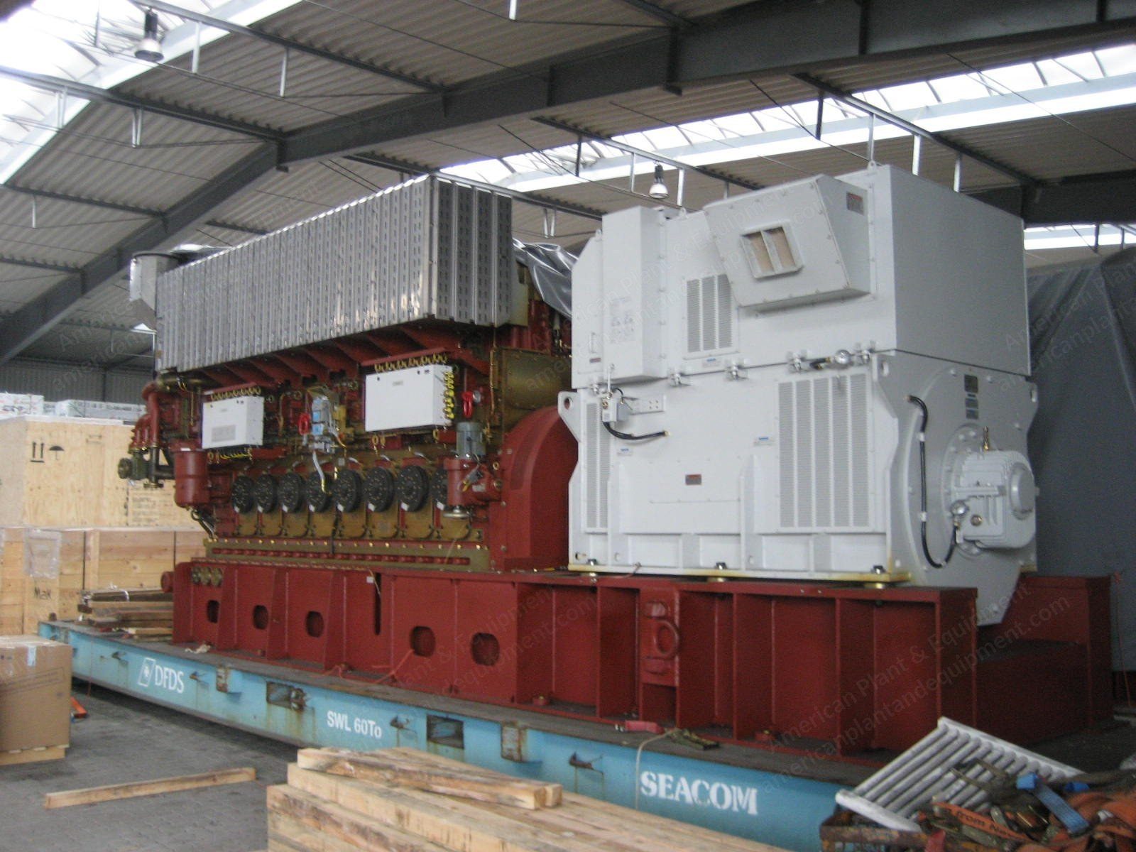 Heavy fuel oil generator set with alternator, mounted on a shipping cradle.