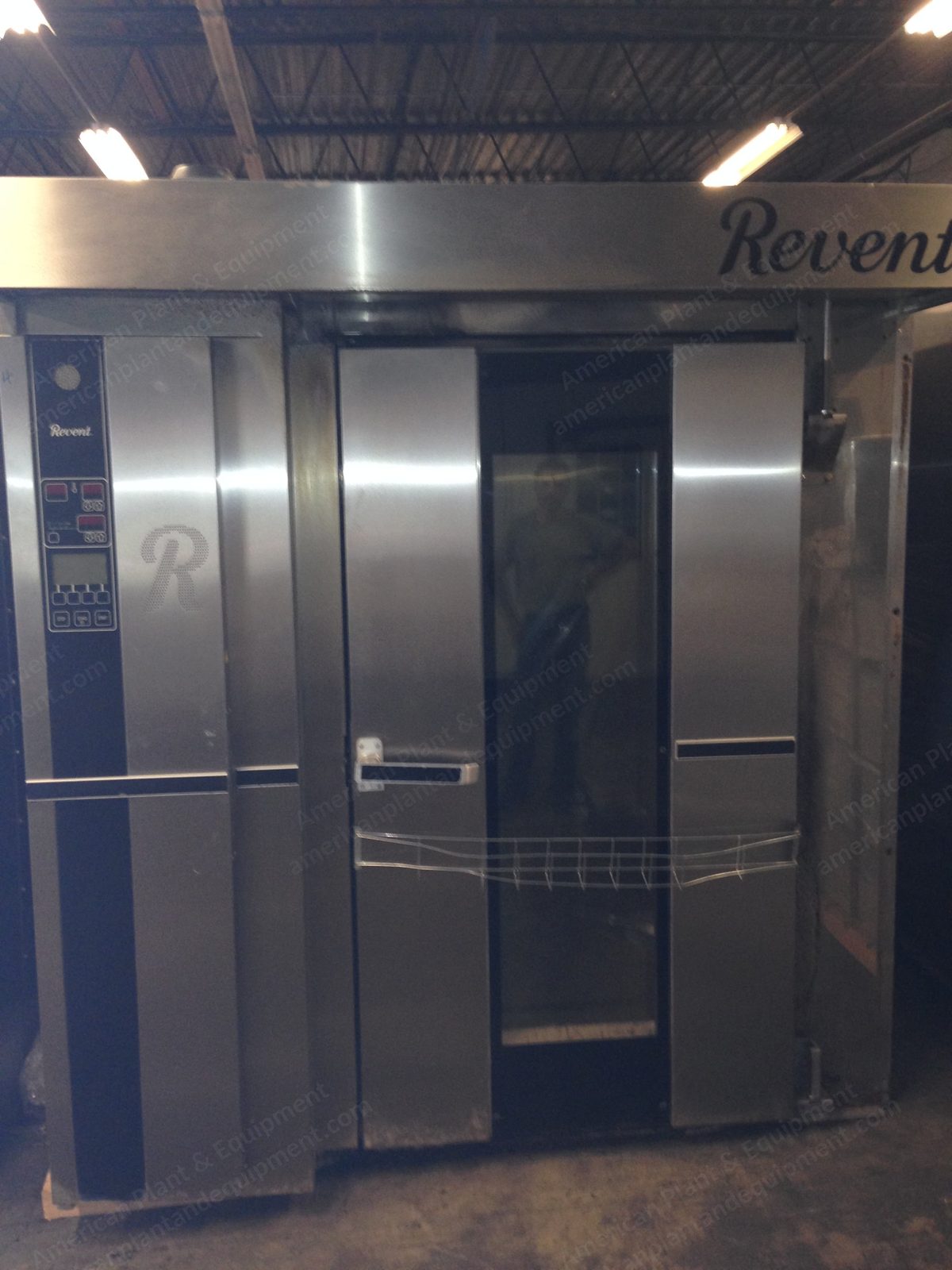 Stainless steel double-rack gas oven with the door closed in a bakery.