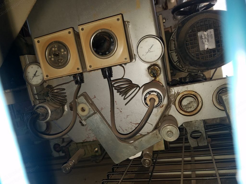 Close-up of pressure gauges and controls on a chocolate depositor.