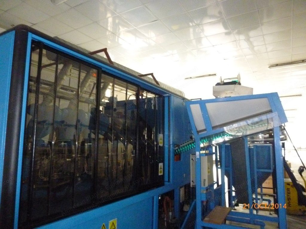 Linear reheat stretch blow molding machine with blue frame and clear guarding.