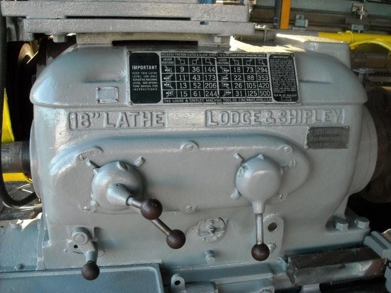 Cast headstock of a long-bed engine lathe with the maker's name and capacity cast into the metal.